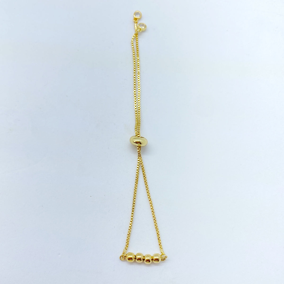 Pulsera bolitas doradas